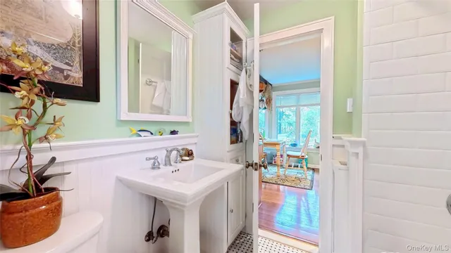 a bathroom with a sink a mirror and a shower