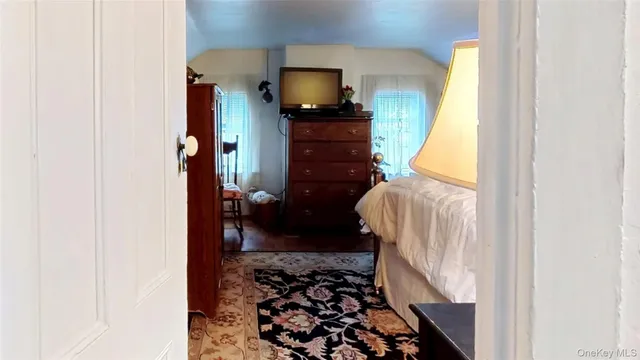 a bedroom with a bed and a television