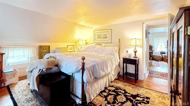 a bed sitting in a bedroom next to a window