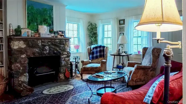 a living room with furniture a table and a fireplace