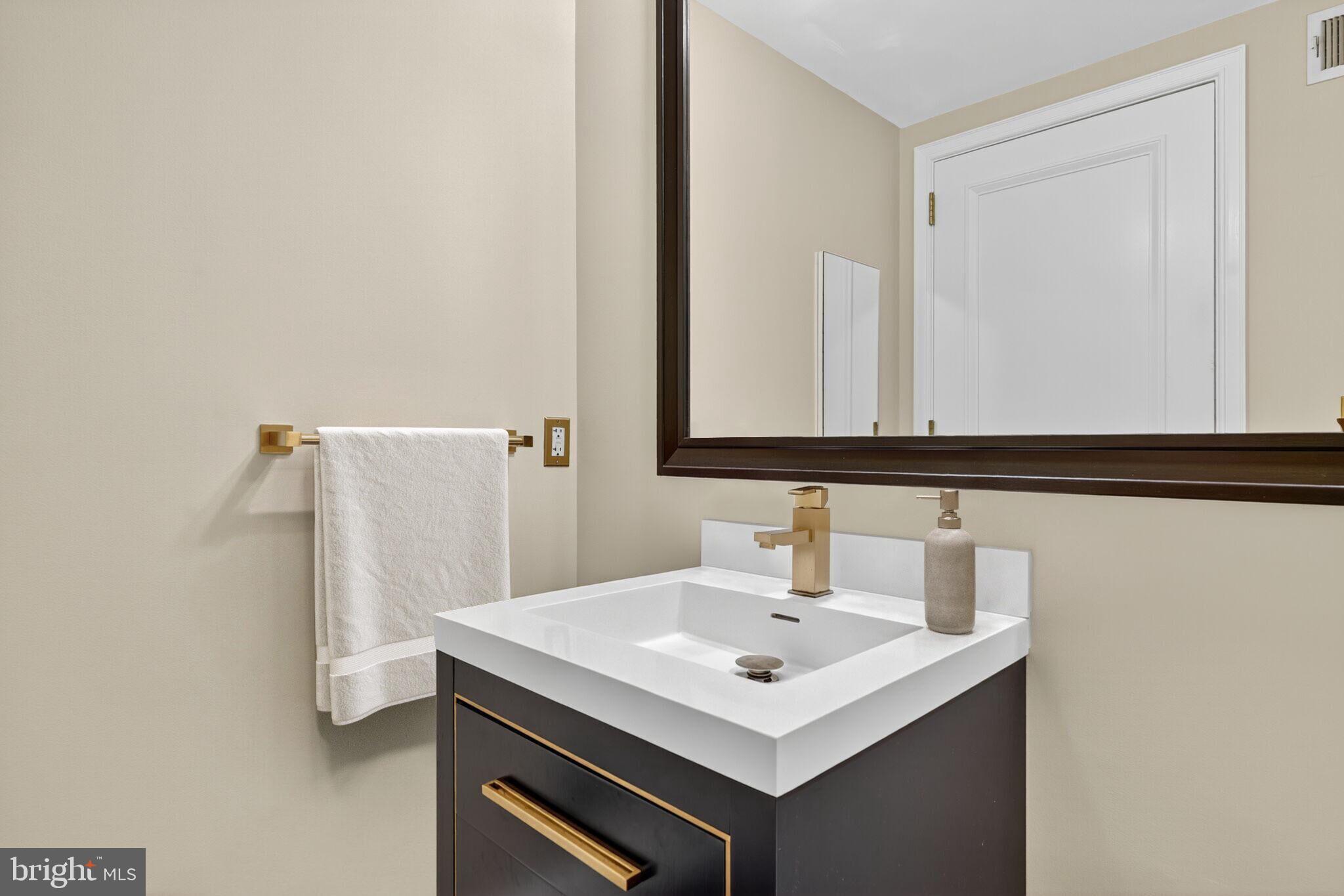 1155 23rd Street Northwest, Unit 3D Washington, DC 20037 - Photo 11 of 22 a bathroom with a sink and a mirror