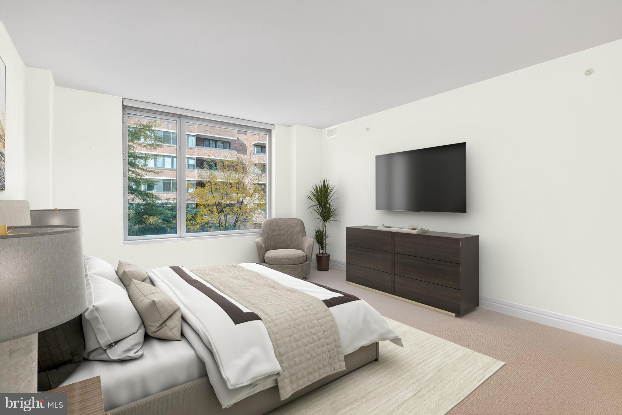 1155 23rd Street Northwest, Unit 3D Washington, DC 20037 - Photo 13 of 22 a bedroom with a bed and a flat screen tv