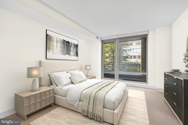 a bedroom with a bed and a lamp next to a window