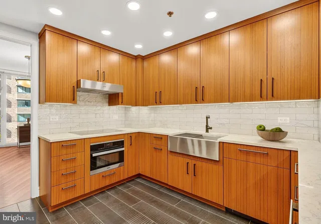 a kitchen with stainless steel appliances granite countertop wooden cabinets a sink and dishwasher