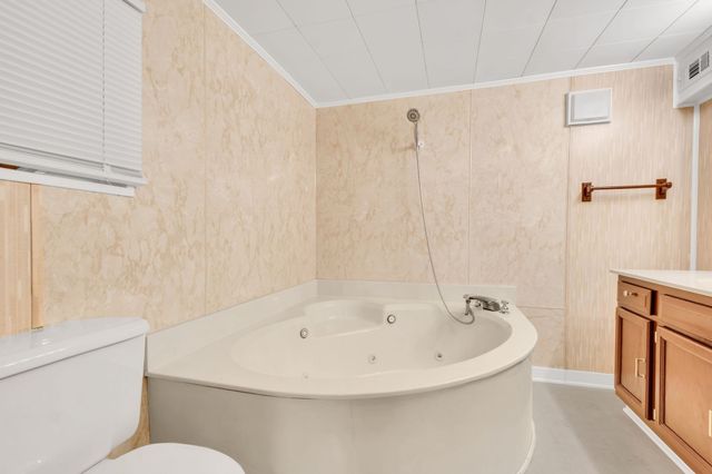 a white bath tub sitting next to a white toilet