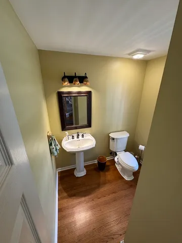 a kitchen with stainless steel appliances granite countertop a refrigerator a stove a sink dishwasher and white countertops with wooden floor