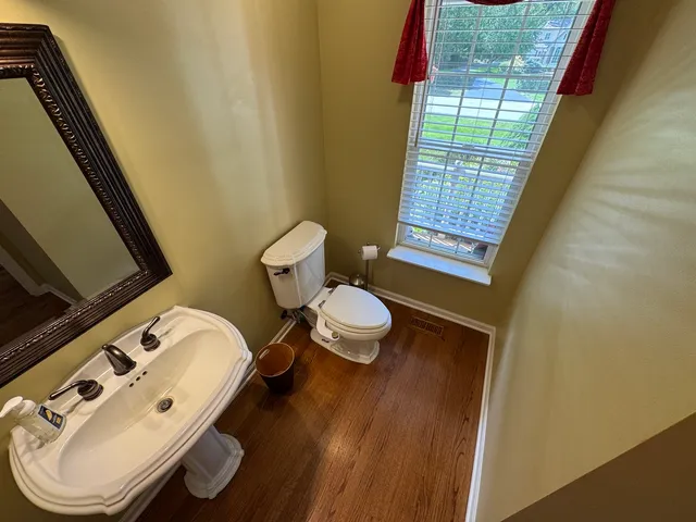 a bedroom with a bed dresser and a window