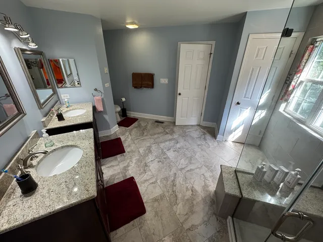 a view of a dining room with furniture and a chandelier