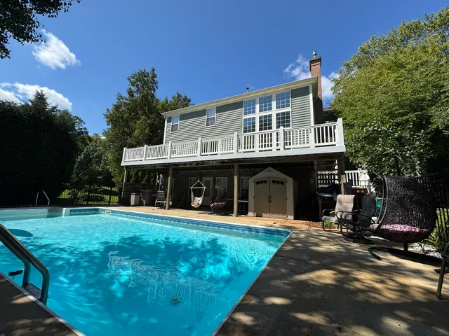 a balcony with wooden floor and outdoor seating