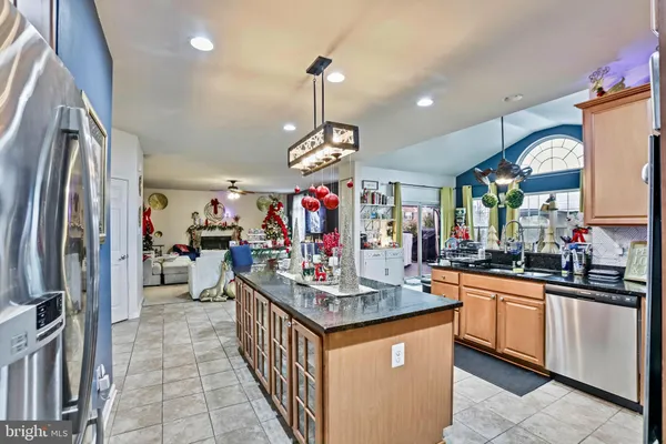 a dining hall with stainless steel appliances a dining table and chairs