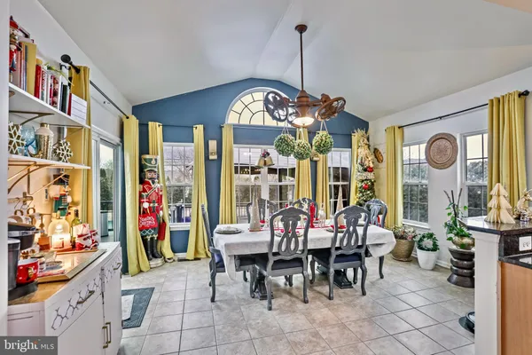 a living room with lots of furniture and chandelier