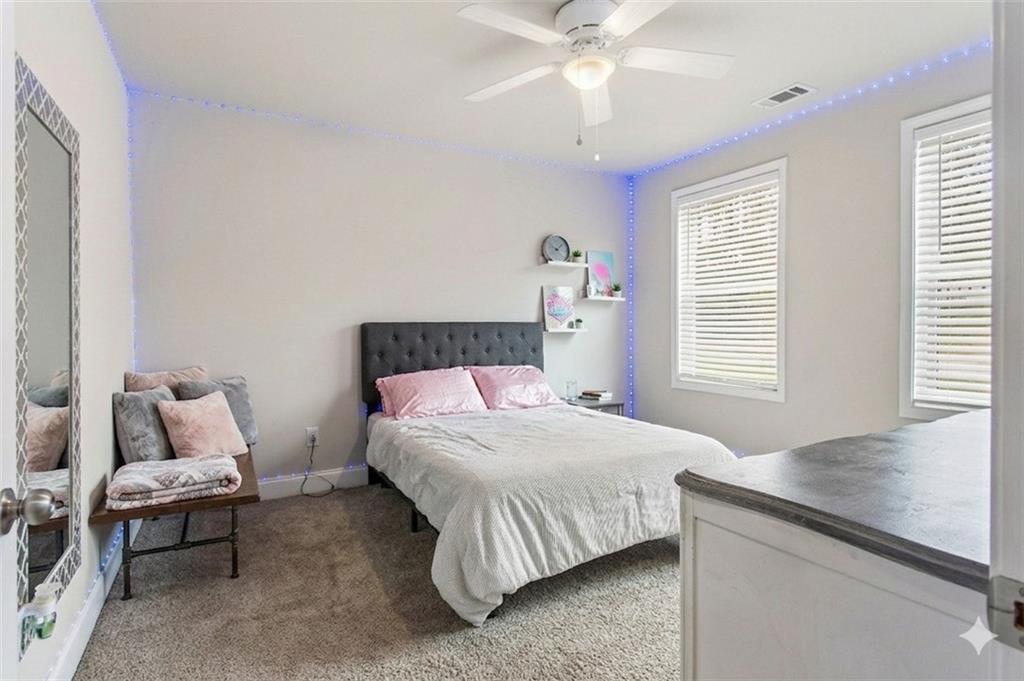 171 Strickland Loop Forsyth, GA 31029 - Photo 18 of 25 a bedroom with a bed and a chandelier