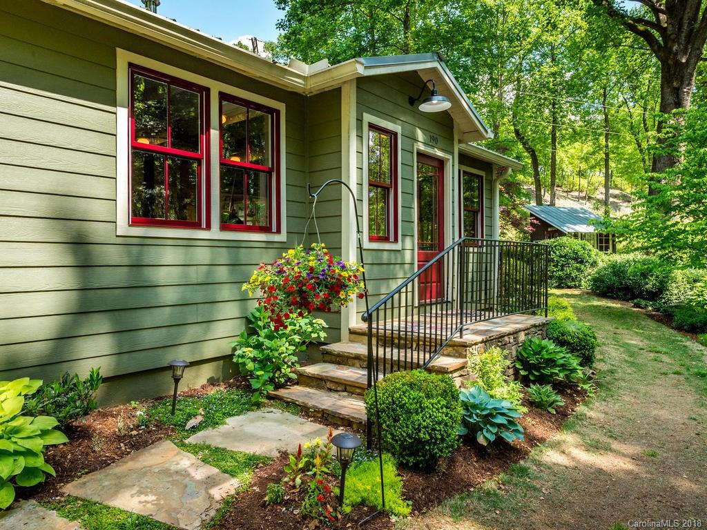 190 Euit Smith Road Tryon, NC 28782 - Photo 2 of 36 a front view of a house with a garden