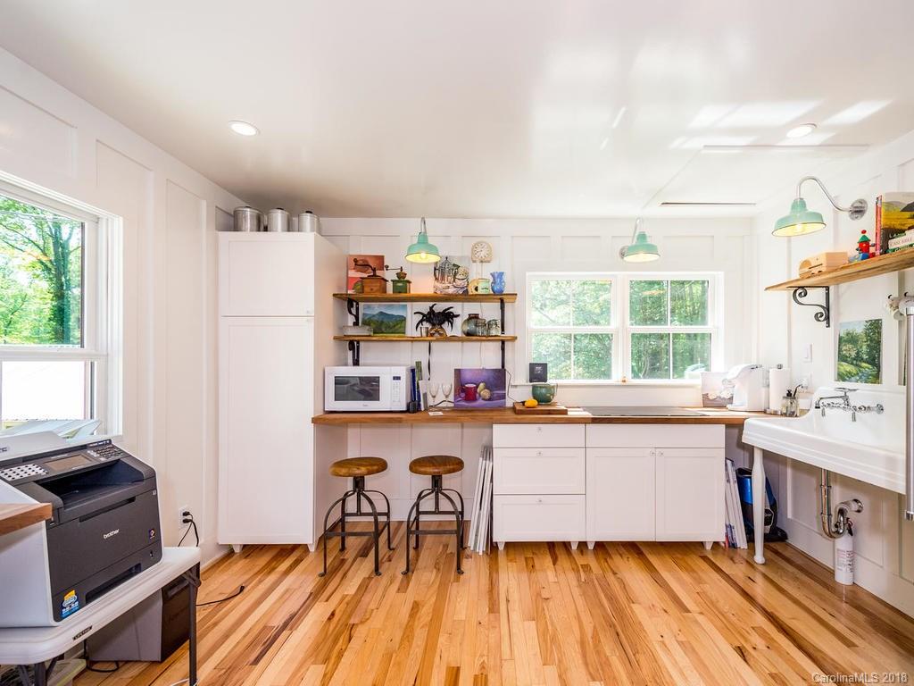 190 Euit Smith Road Tryon, NC 28782 - Photo 26 of 36 a kitchen with a sink a stove a refrigerator and a window