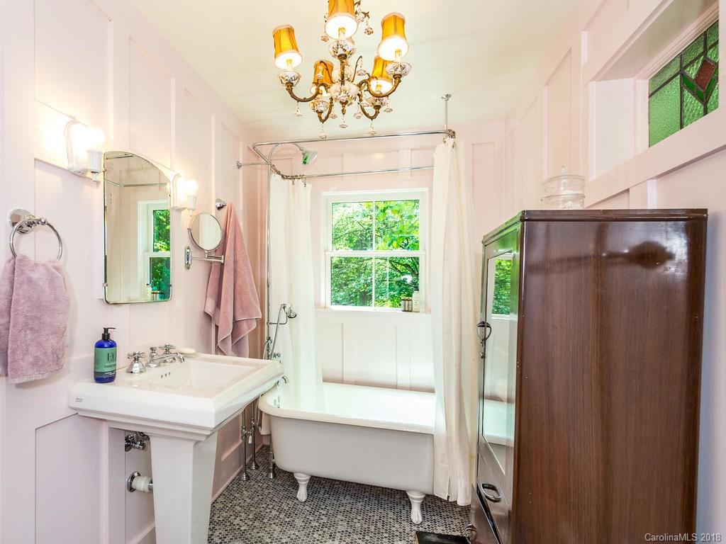 190 Euit Smith Road Tryon, NC 28782 - Photo 29 of 36 a bathroom with a sink a mirror and a bathtub