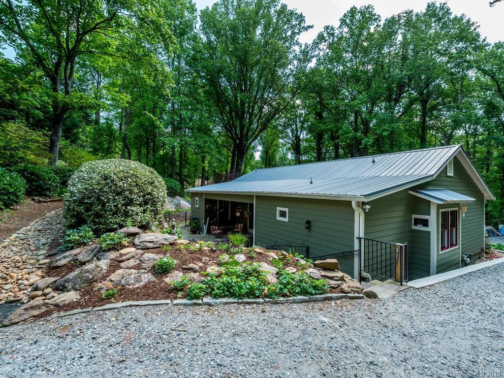 190 Euit Smith Road Tryon, NC 28782 - Photo 32 of 36 a front view of a house with a garden