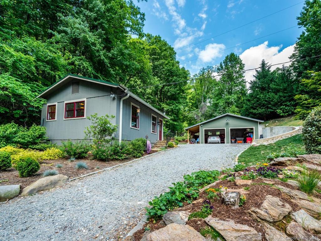 190 Euit Smith Road Tryon, NC 28782 - Photo 33 of 36 a view of house with a yard and potted plants