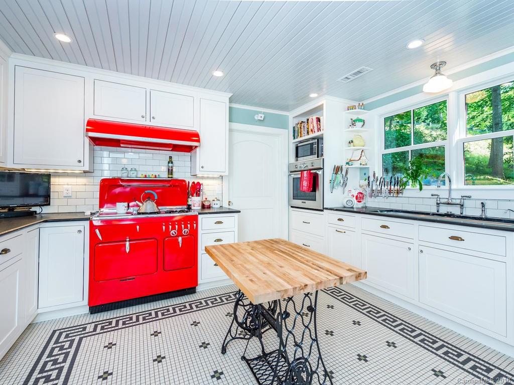 190 Euit Smith Road Tryon, NC 28782 - Photo 7 of 36 a kitchen that has a stove a table and chairs in it