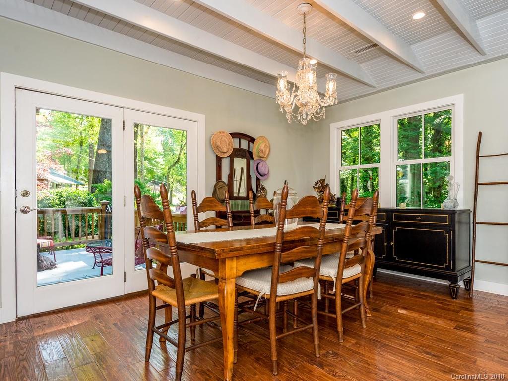 190 Euit Smith Road Tryon, NC 28782 - Photo 10 of 36 a view of a dining room with furniture a chandelier and wooden floor