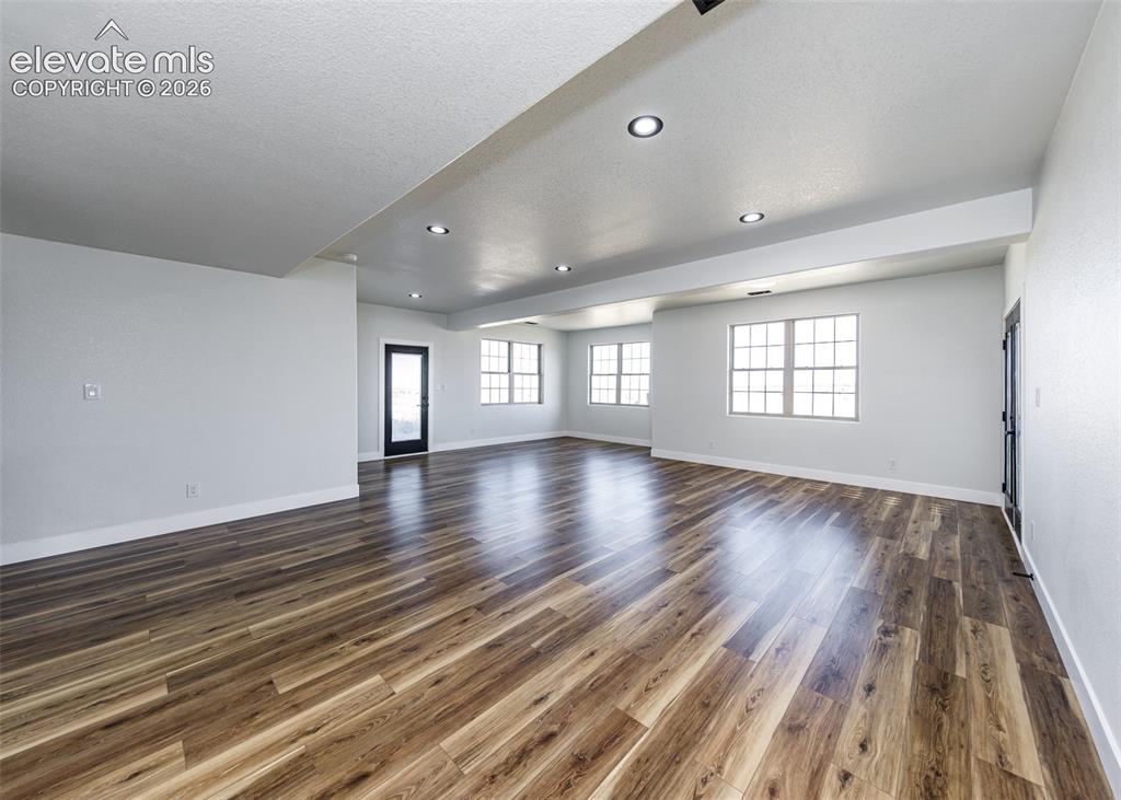 1120 Newton Road Pueblo, CO 81005 - Photo 22 of 46 wooden floor in an empty room with a window