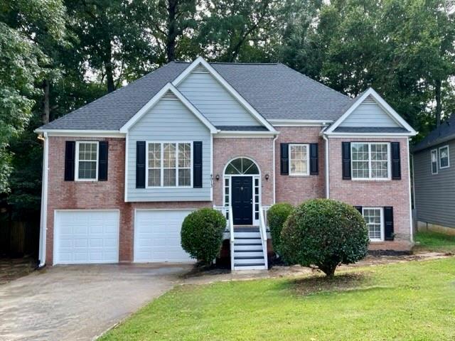 4913 Baker Ridge Place Acworth, GA 30101 - Photo 1 of 1 a front view of a house with garden
