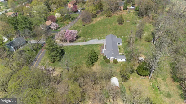 an aerial view of a house with a yard