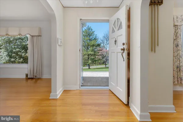 a view of a hallway with wooden floor and closet