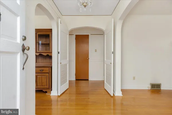 a view of a room with wooden floor and a large window