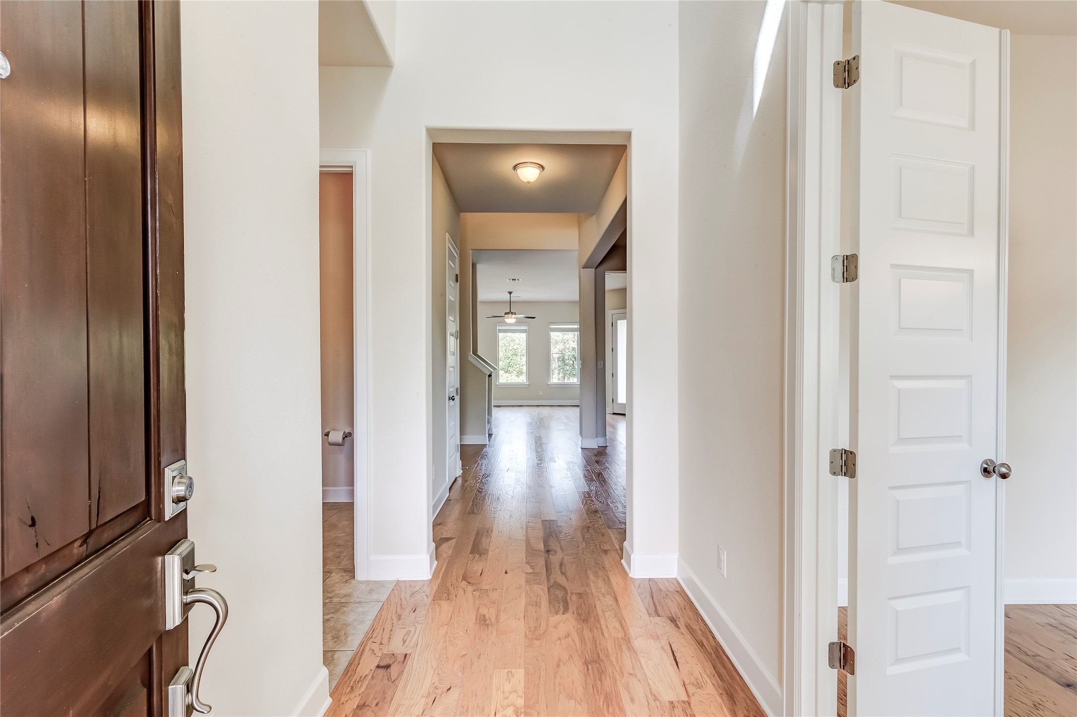 345 Fort Cobb Way Georgetown, TX 78628 - Photo 5 of 38 An inviting foyer leads into a flowing layout with warm wood flooring and high ceilings.