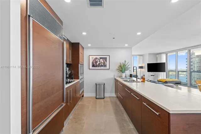 a kitchen with stainless steel appliances a refrigerator and a stove top oven