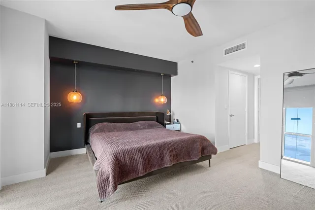 a bedroom with a bed and a night stand