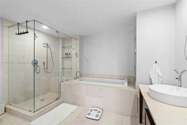 a bathroom with a shower and a sink
