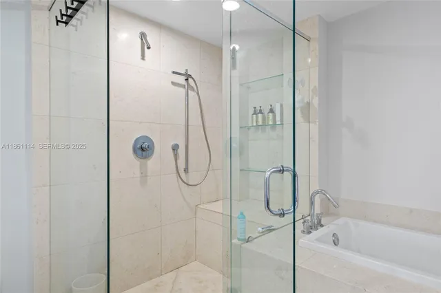 a bathroom with a bath tub and shower