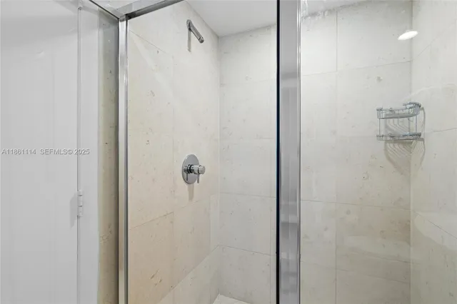 a bathroom with a sink a mirror and a shower