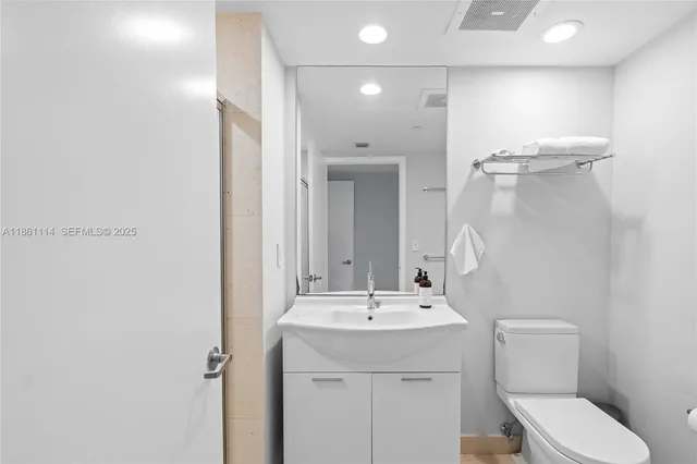 a utility room with dryer washer and sink
