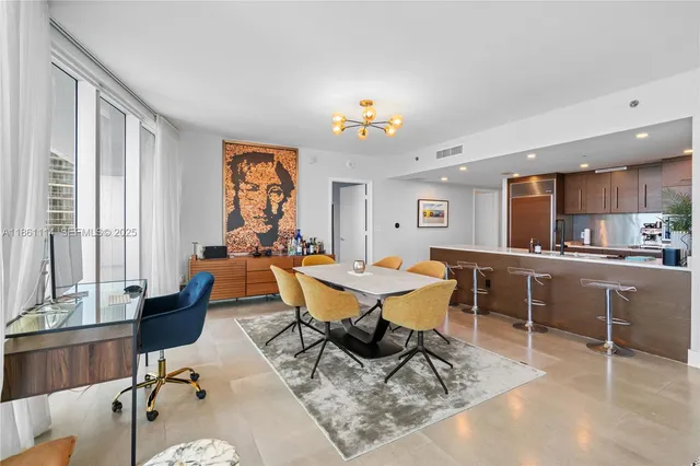 a living room with furniture a dining table and a window