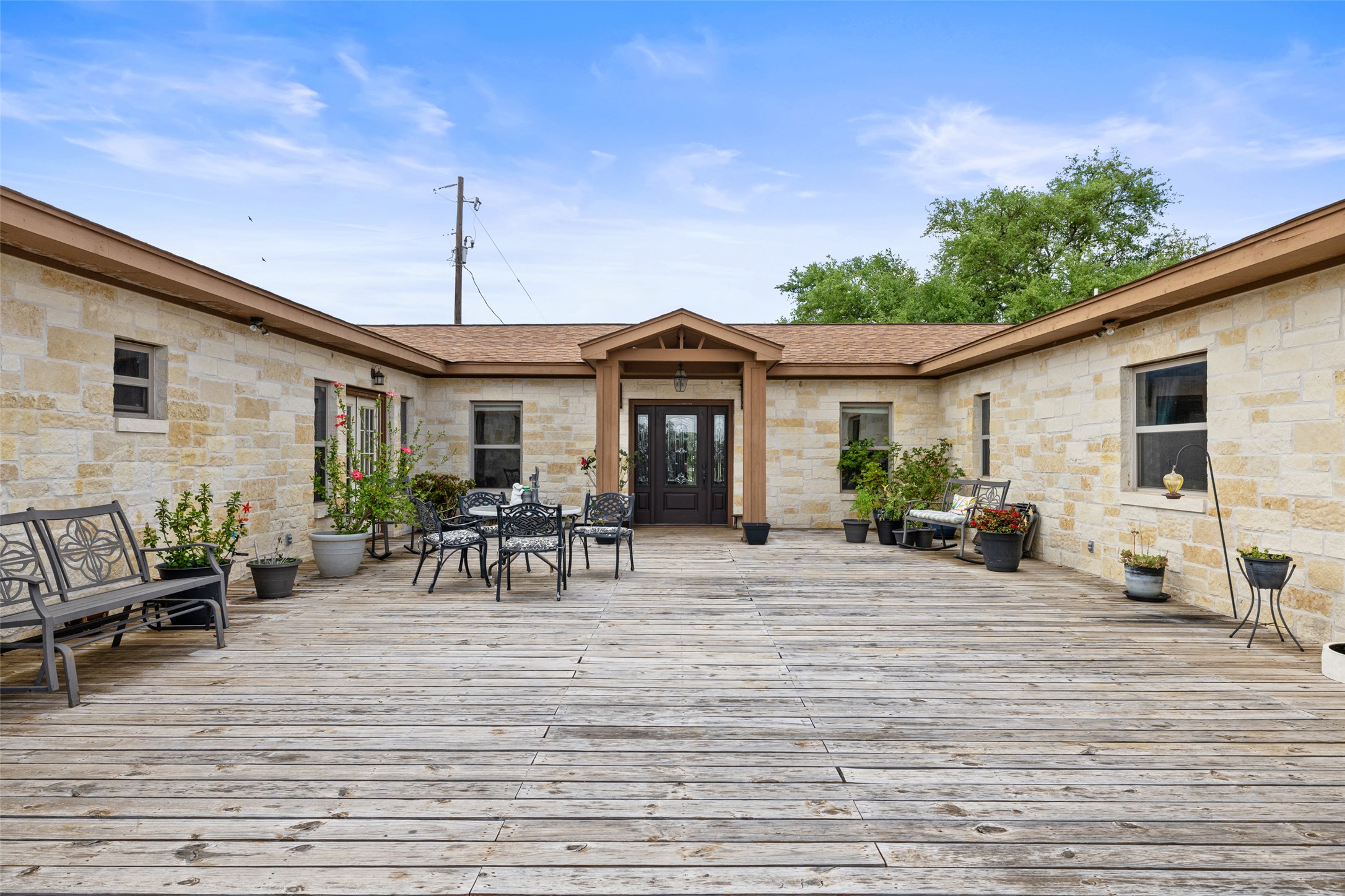2966 Rm 165 Dripping Springs Dripping Springs, TX 78620 - Photo 6 of 23 Expansive wood deck patio surrounded by a stone exterior