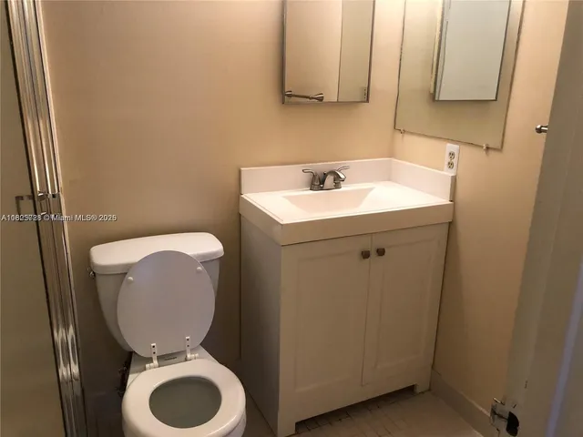 a bathroom with a shower a toilet and sink