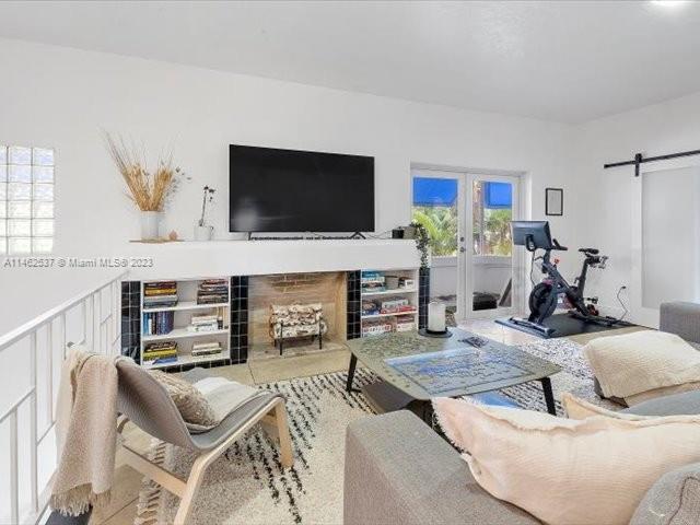 600 Surfside Boulevard Surfside, FL 33154 - Photo 12 of 31 a living room with furniture fireplace and a flat screen tv