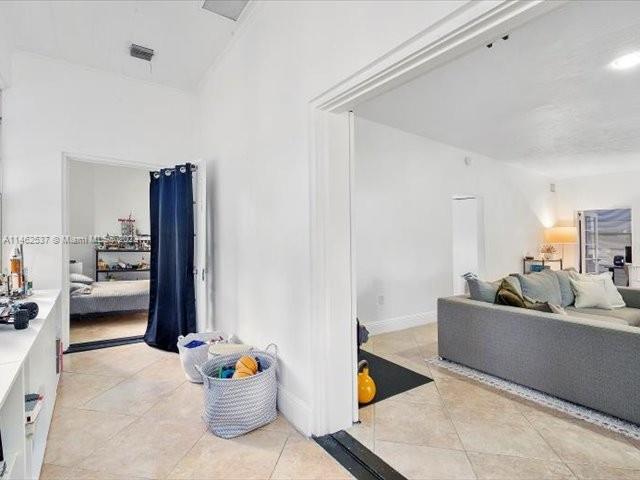 600 Surfside Boulevard Surfside, FL 33154 - Photo 14 of 31 a living room with furniture and a flat screen tv