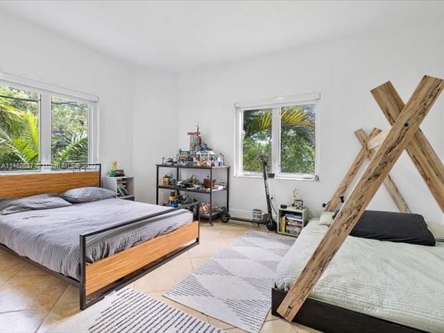 600 Surfside Boulevard Surfside, FL 33154 - Photo 17 of 31 a bedroom with a bed and a window