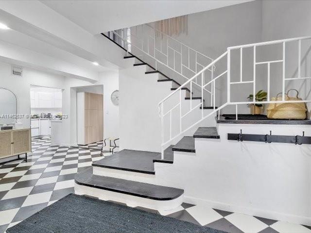 600 Surfside Boulevard Surfside, FL 33154 - Photo 25 of 31 a view of staircase with open kitchen view