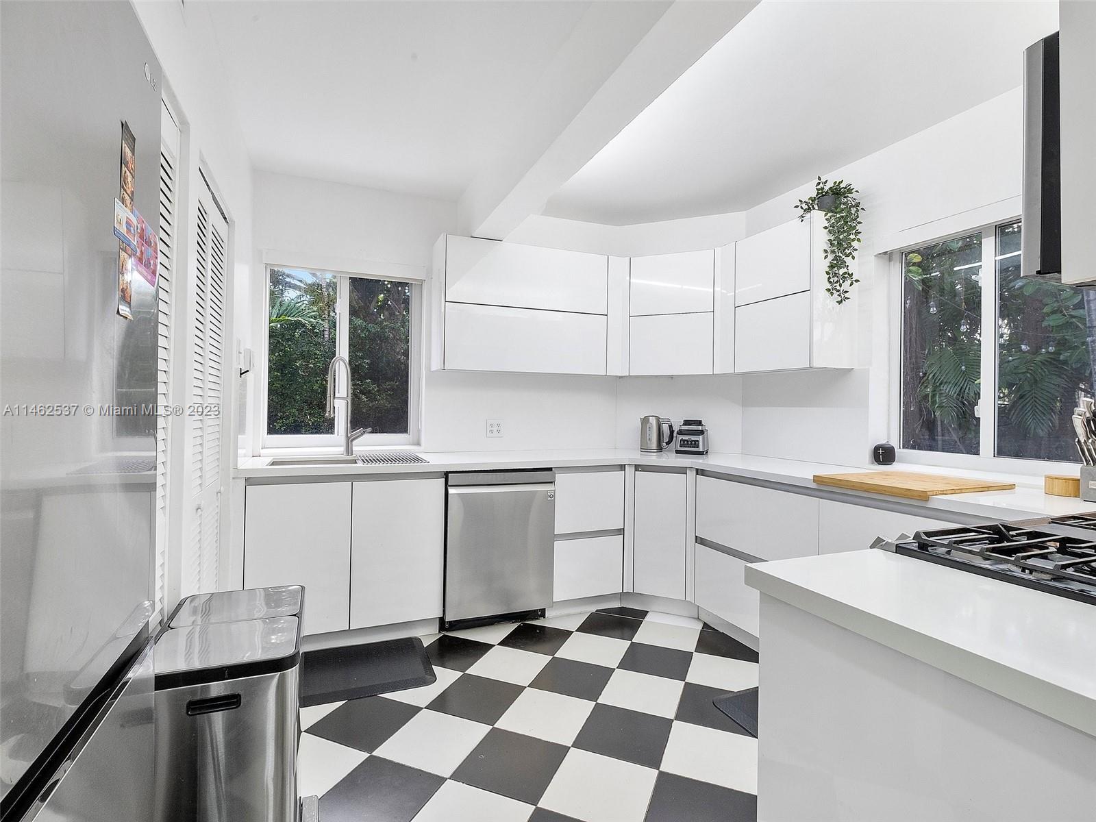 600 Surfside Boulevard Surfside, FL 33154 - Photo 29 of 31 a kitchen with a checkered floor and white cabinets