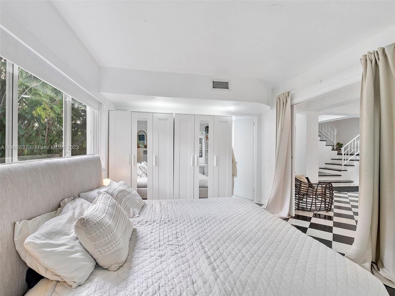 600 Surfside Boulevard Surfside, FL 33154 - Photo 30 of 31 a bedroom with a bed and a chair