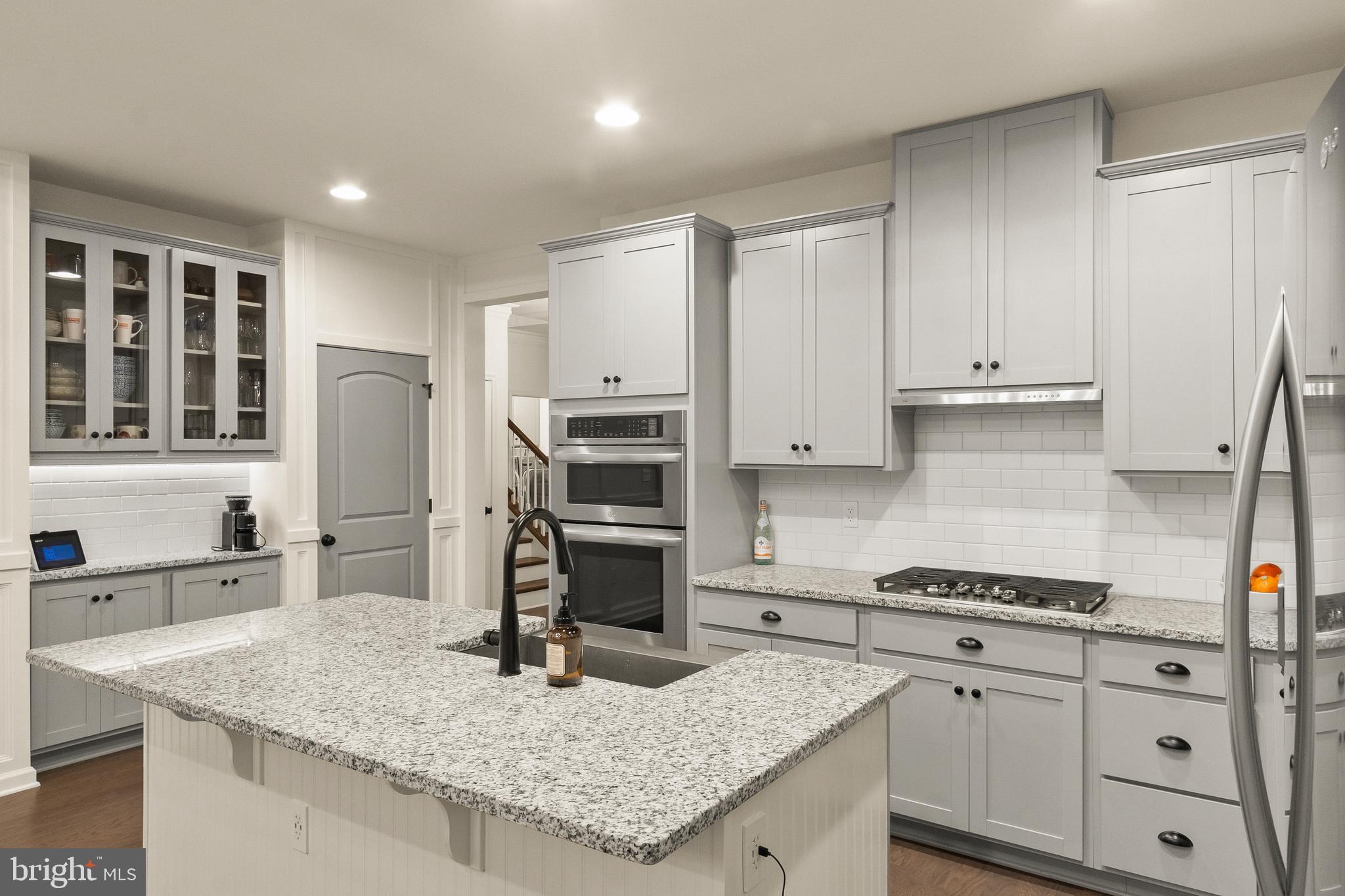 407 Sun Boulevard Bear, DE 19701 - Photo 18 of 69 a kitchen with granite countertop a sink stainless steel appliances and cabinets