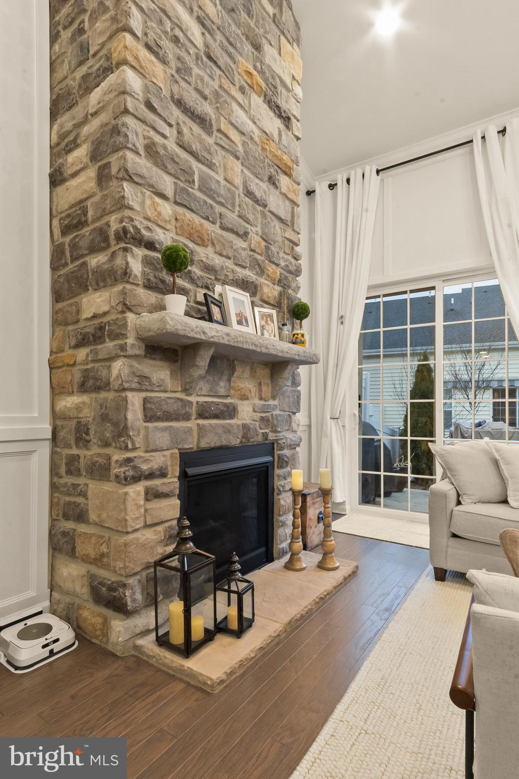 407 Sun Boulevard Bear, DE 19701 - Photo 28 of 69 a living room with furniture a fireplace and a floor to ceiling window