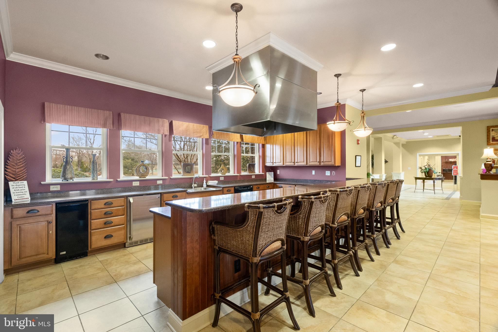 407 Sun Boulevard Bear, DE 19701 - Photo 58 of 69 a kitchen with stainless steel appliances a table chairs sink and cabinets