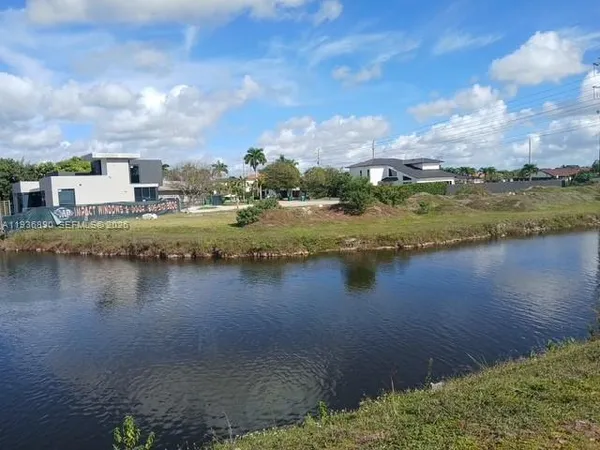 a view of a lake with houses in the back