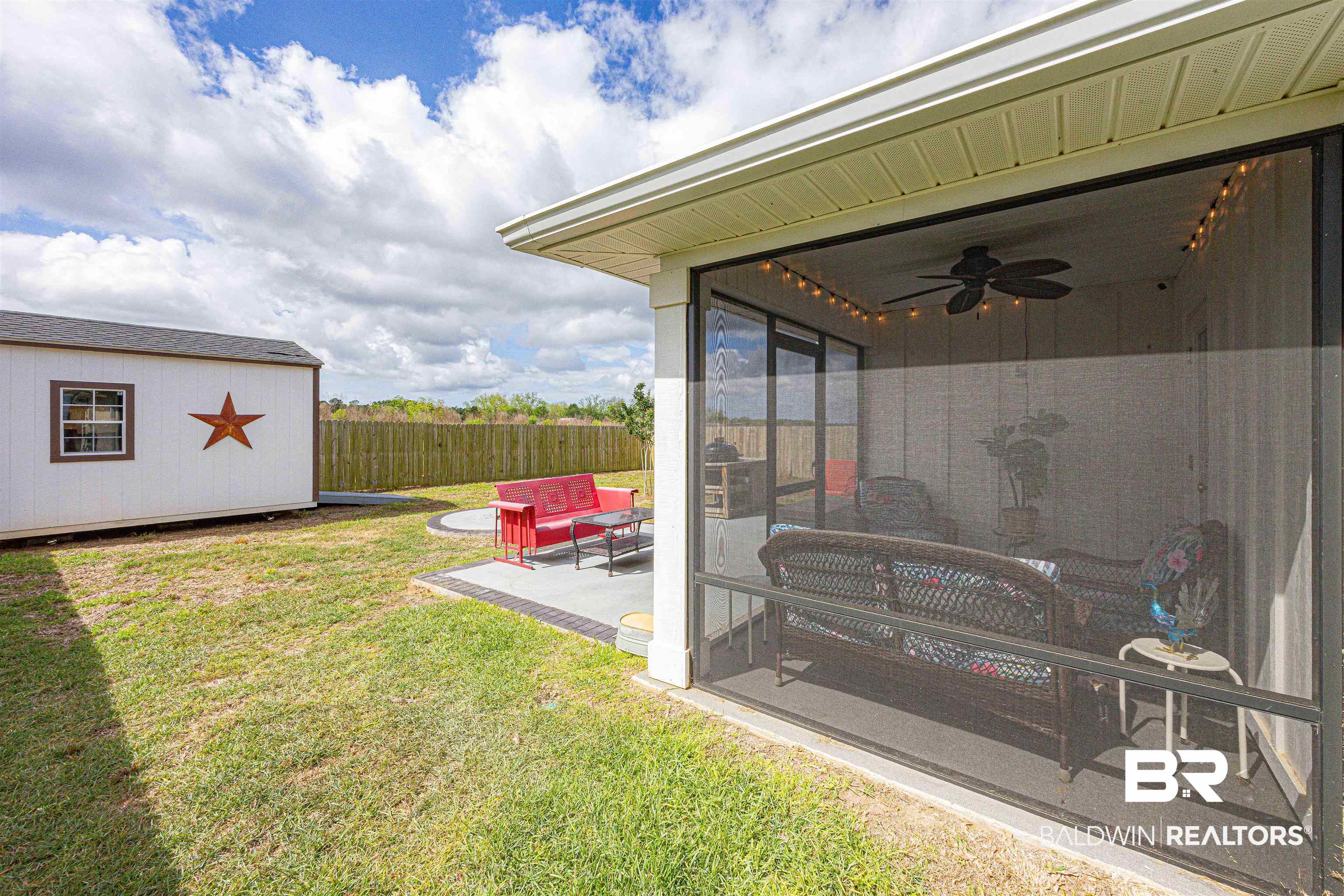 14843 Forsythia Loop Silverhill, AL 36576 - Photo 41 of 51 Fenced yard featuring a ceiling fan, a patio, an outdoor lounge area, and a shed