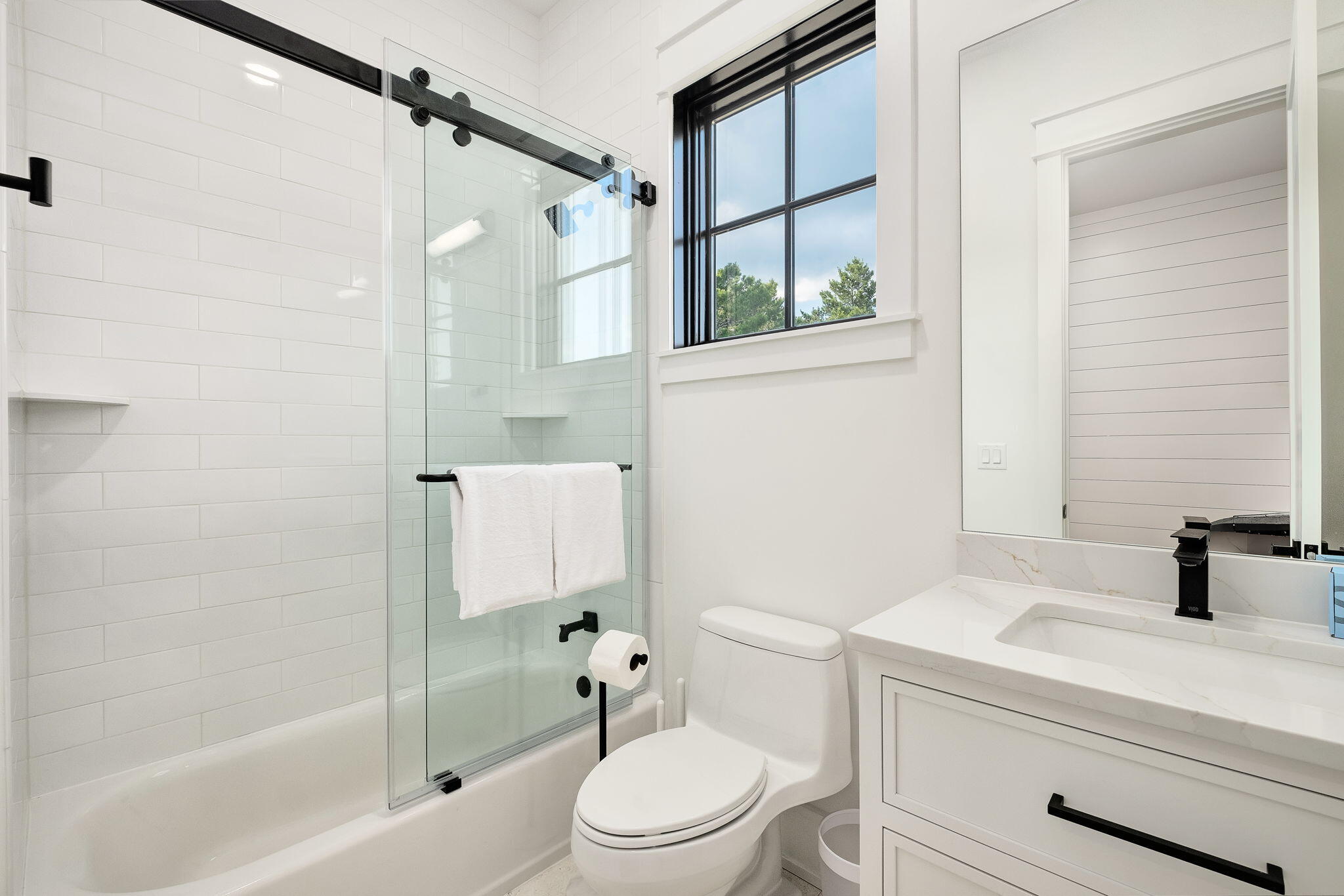 7570 East County Highway 30A Watersound, FL 32461 - Photo 29 of 64 a bathroom with a sink a toilet and a bathtub